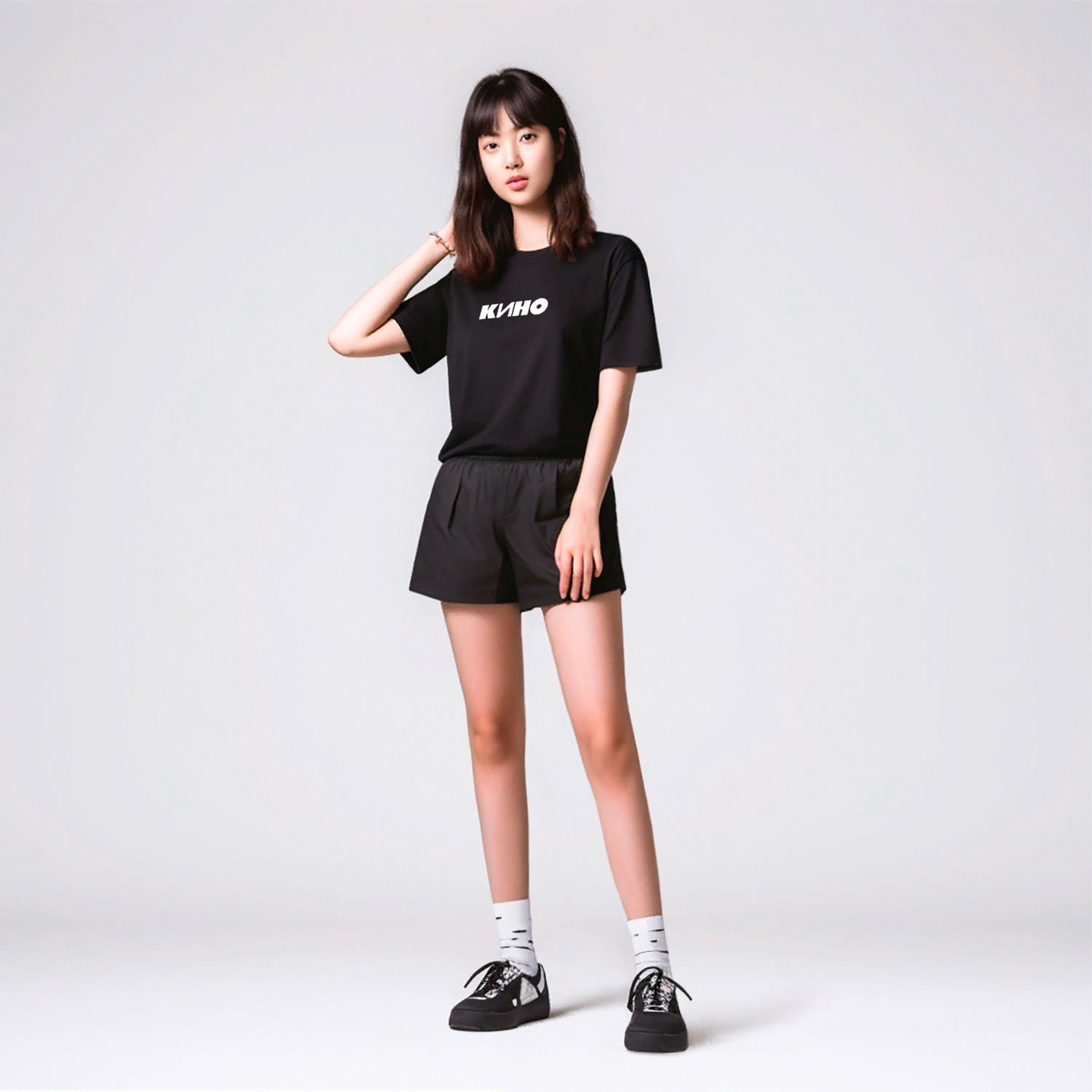 Cute korean girl in short shorts wearing black T-shirt with KINO logo